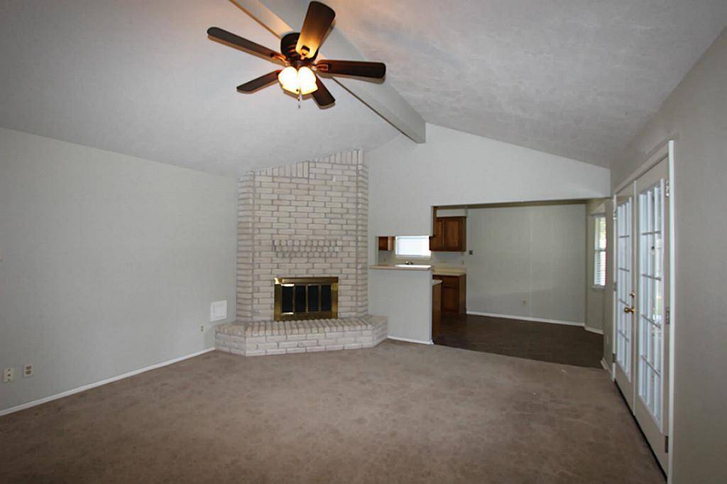 Large living room with high ceilings, updated light fixtures and beautiful french doors.