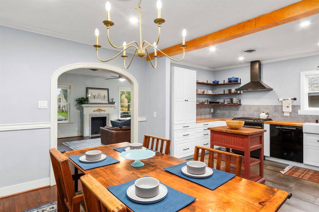 A view from the dining room to the living room at the front of the home. The arched transition is an original architectural element of the home.