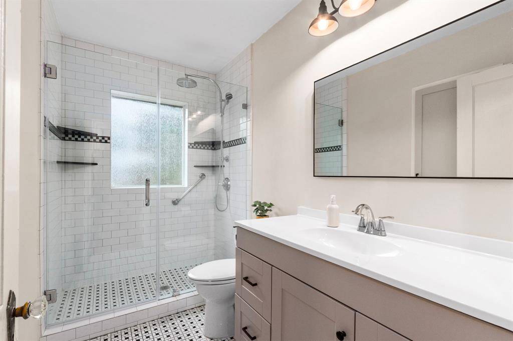 The gorgeous, fully updated bath is centrally located between Bedrooms 1 and 2, with hallway access.
