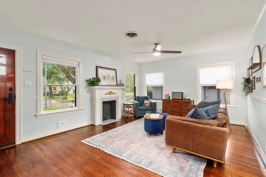 Gleaming hardwood floors have been impeccably maintained throughout the years, allowing you to blend the historic and the new. The original gas fireplace is intact, but not currently in use. Wood-framed windows overlook the front and side yard, providing the perfect spot to watch the world go by from the comfort of your favorite chair. Updated lighting and window coverings are found throughout the home, promoting privacy while still allowing natural light to infuse the interior spaces.