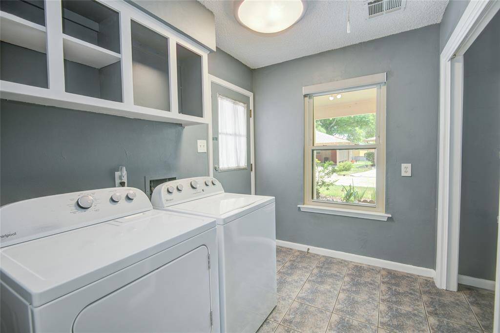 The laundry room has carport access and entry to the upstairs attic.