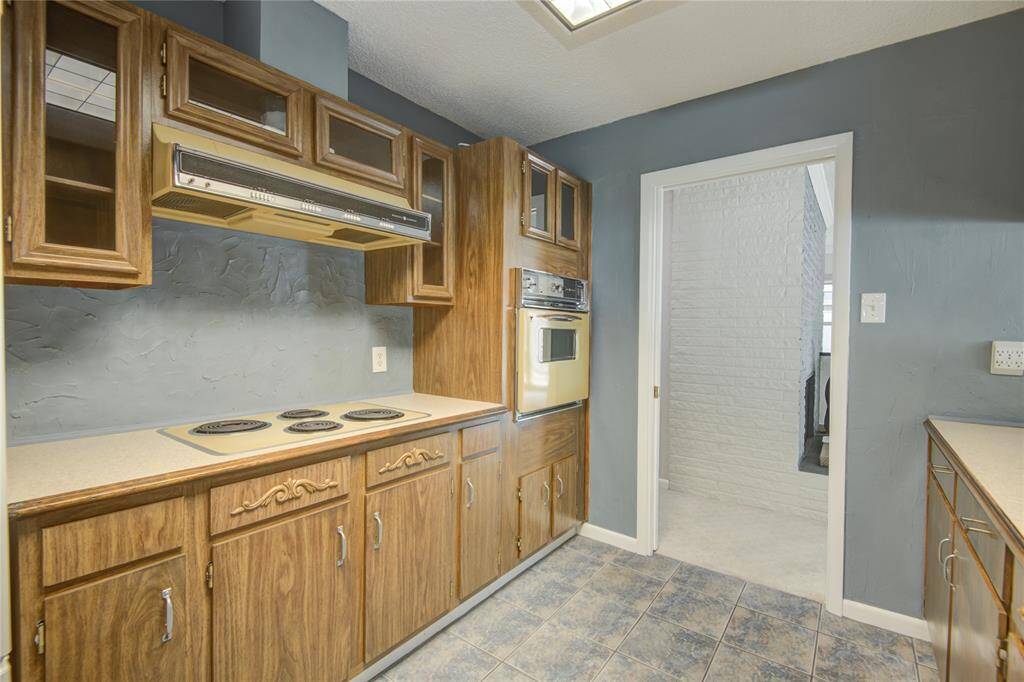 From this angle you see the cooktop and oven area looking out to family room hallway.