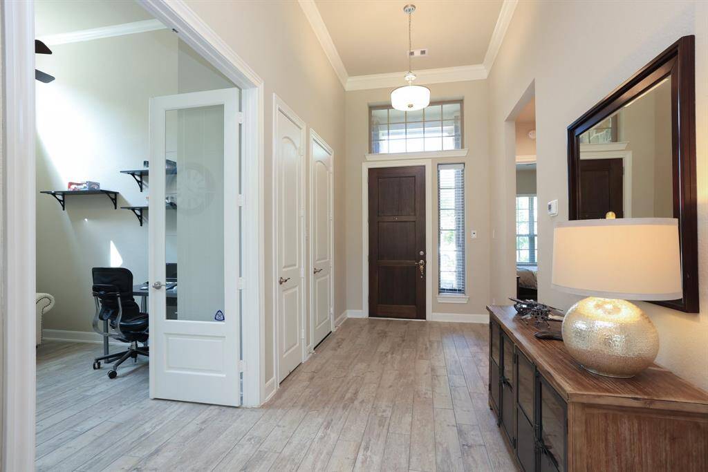 Highlights include durable wood-like tile flooring throughout all main living areas, a large direct vent fireplace for cozy gatherings, and a covered back porch perfect for outdoor relaxation or entertaining.