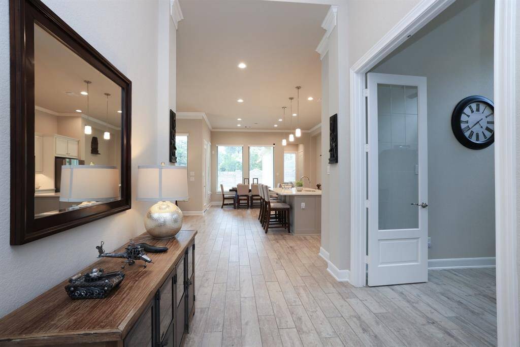 Light and bright throughout, this home features abundant recessed lighting, a neutral paint palette, elegant crown molding, and tasteful window coverings, creating a polished and inviting ambiance in every room.