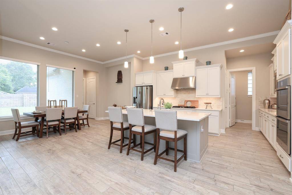 The modern layout of the kitchen, dining, and living areas allows for plenty of versatility in furniture arrangement, catering to your personal style and needs. Family and friend gatherings will be enjoyed in this welcoming space, with the kitchen conveniently situated in the heart of the home, fostering easy interaction and connection while entertaining.