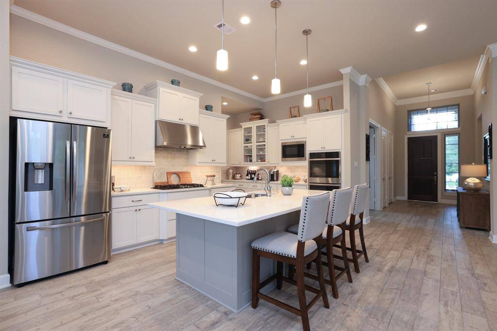 Both pendant and recessed lighting are thoughtfully incorporated throughout the home, adding warmth, style, and functional illumination to key living spaces.