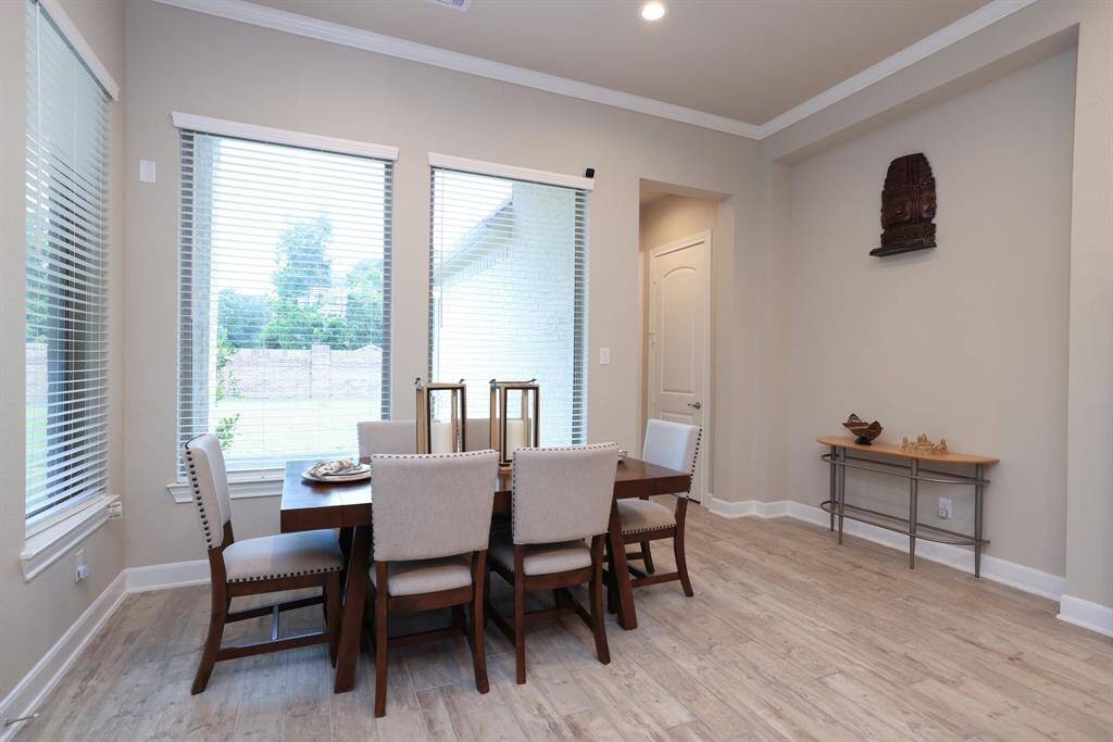 Whether you prefer casual or formal dining, this versatile space adapts to your needs. Enjoy views of your backyard through large windows, and take advantage of the patio door for easy access to the covered back patio, perfect for indoor-outdoor living.