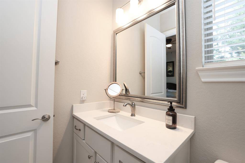 This meticulously maintained home features window coverings throughout, offering both style and privacy while showcasing the care and attention given to every detail.