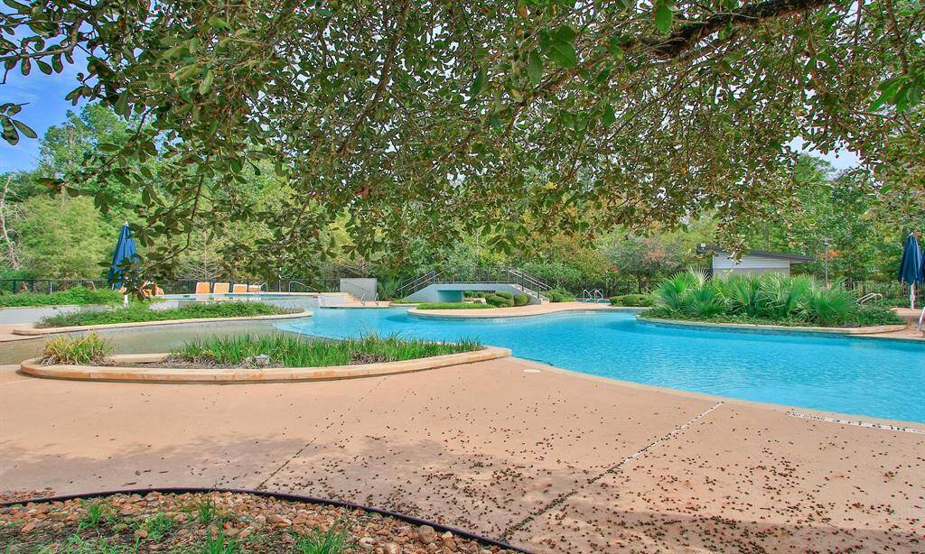 The 9,000-sq.-ft. Woodson’s Club offers premier amenities including a 24-hour fitness center, dedicated kids' room, indoor/outdoor gathering spaces, a resort-style pool with lazy river and island, lap pool, sculpted nature-themed play garden, event lawns, and fully stocked catch-and-release lakes, all designed for recreation, relaxation, and connection.