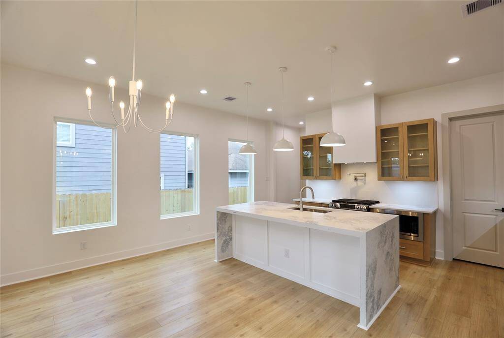 The open floor plan offers seamless access from the kitchen to the dining room, enhancing the flow and making entertaining effortless. 3 large windows enhance the entire area.