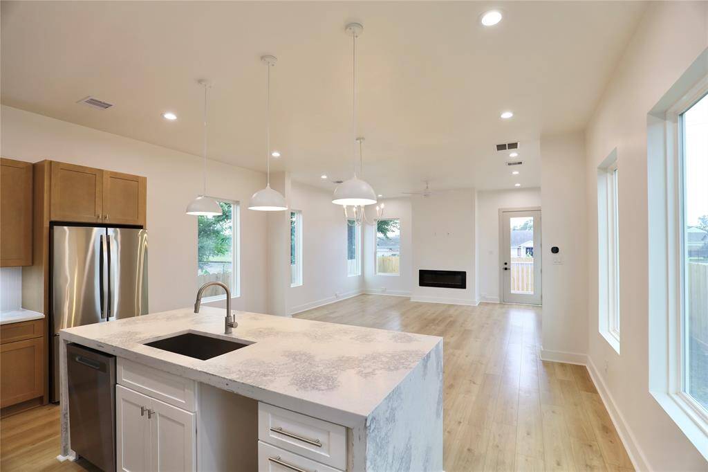 Designed with natural light at the forefront, this home features a builder-upgraded open floor plan, paired with windows that invite an abundance of sunlight, creating a warm and vibrant living space.