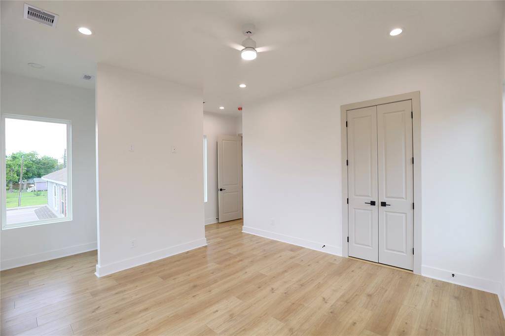 Primary Suite, spacious room with French double doors to your bath. Behind the wall is a spacious bedroom nook for remote work.