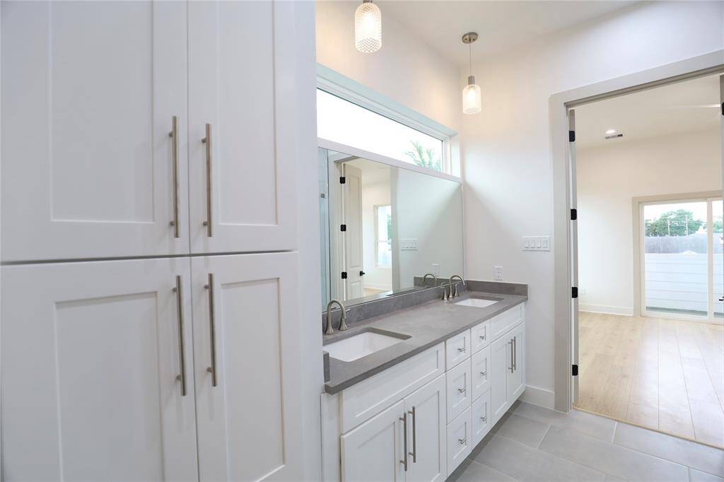 Your primary bath is a storage oasis, featuring a spacious linen closet with soft-close cabinetry and elegant 10" hardware. Two French doors lead into the tranquil primary suite bedroom.