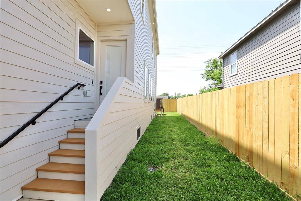 The front door has built-in blinds for added privacy. Notice the cedar-painted stair steps leading to the entryway, where the landing is finished with ALX waterproofing for durability and style.