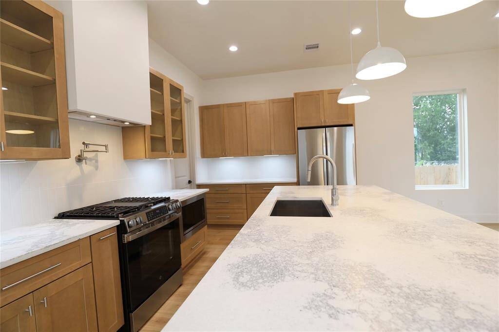 This upgraded appliance package is ready for immediate move-in. The GE gas range features a standout oven with an air fryer setting, perfect for quick, crispy meals. A sleek built-in microwave and GE refrigerator complete the package.