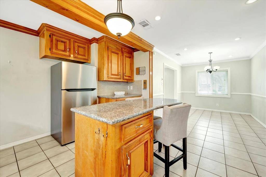 Bright and inviting dining area with tile flooring.