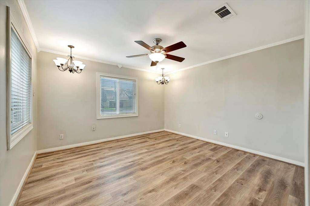 Spacious primary bedroom with ample natural light and elegant fixtures.