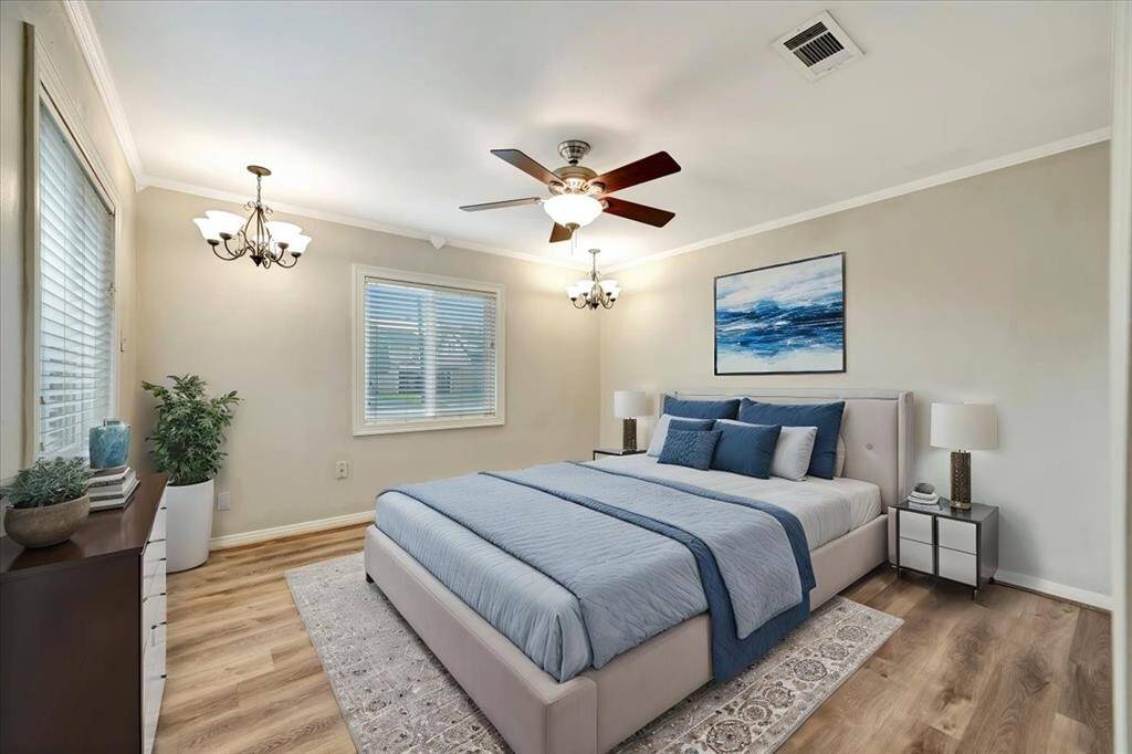 Virtually staged primary bedroom showcasing elegant design and inviting ambiance. Spacious and inviting with elegant lighting and ample natural light.