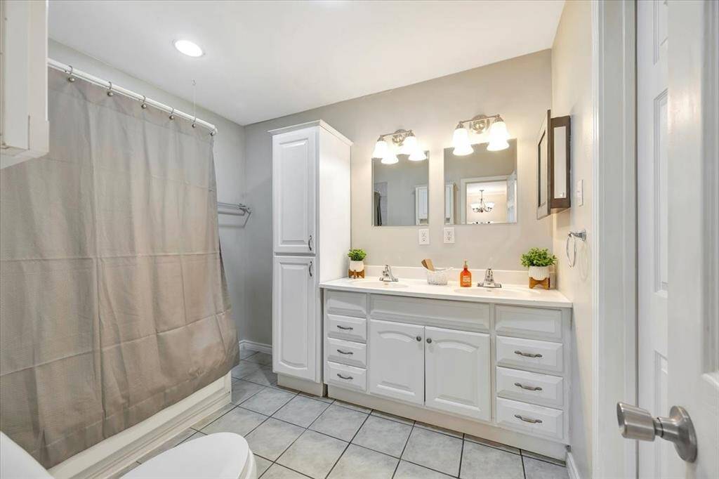 Primary bath featuring a shower and tub combo for ultimate relaxation.