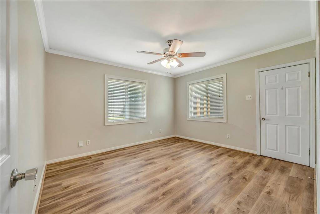 Bright secondary bedroom with expansive windows for ample natural light.
