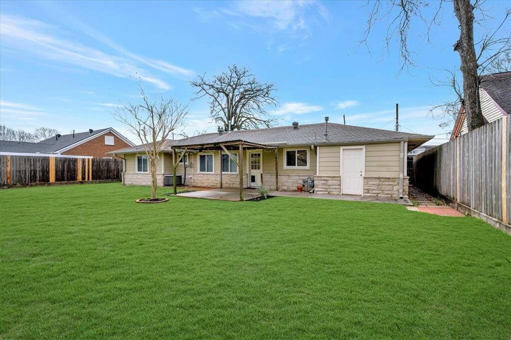 Expansive backyard ideal outdoor fun. Lush greenery enhances the space.