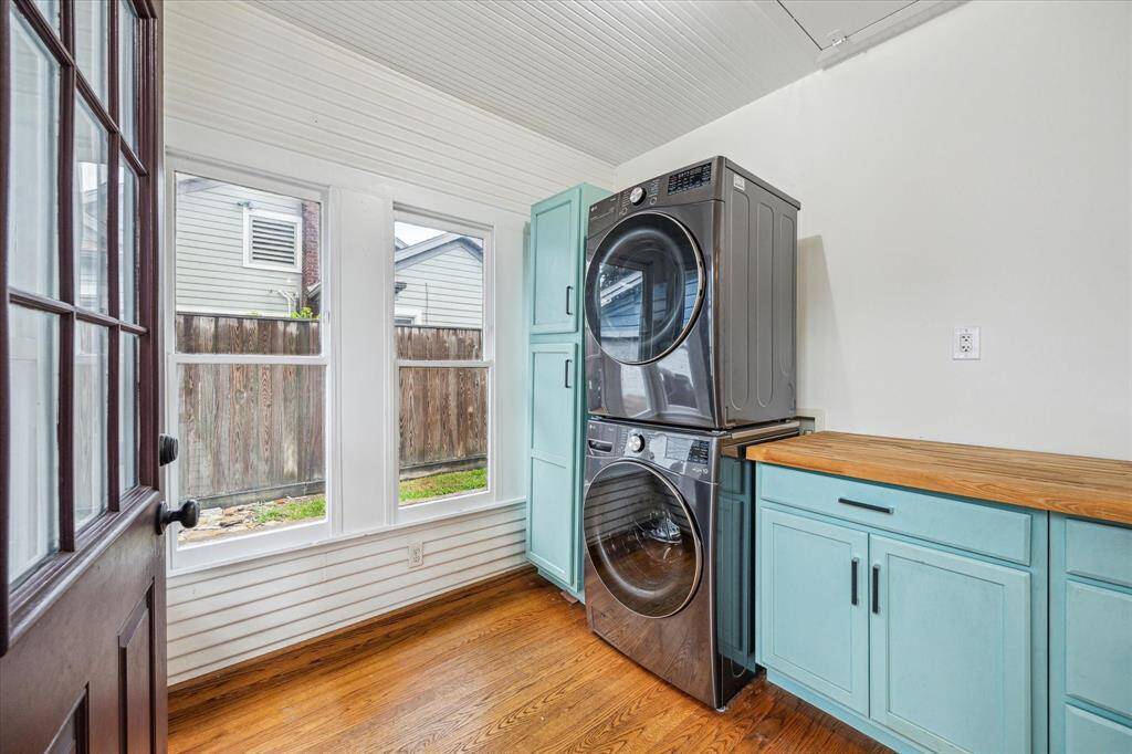 The designated laundry room provides exceptional space, featuring ample storage, countertops, and windows. It also offers convenient access to both the backyard and garage, enhancing its functionality.
