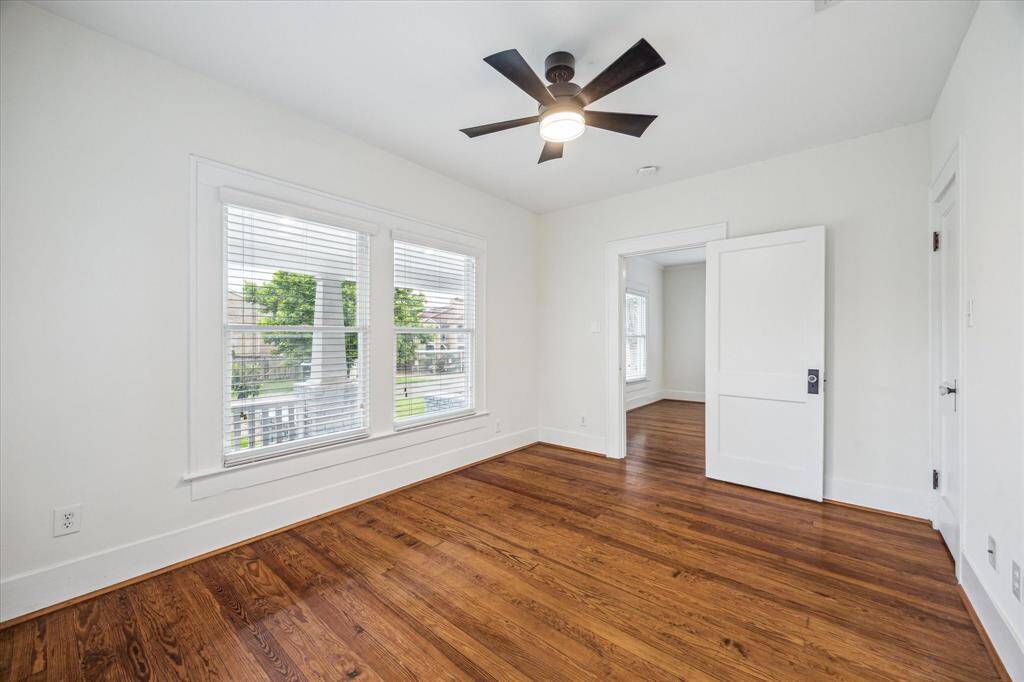 An alternate view of the Front Bedroom highlights its fresh, updated paint and offers a charming view of the delightful front porch.