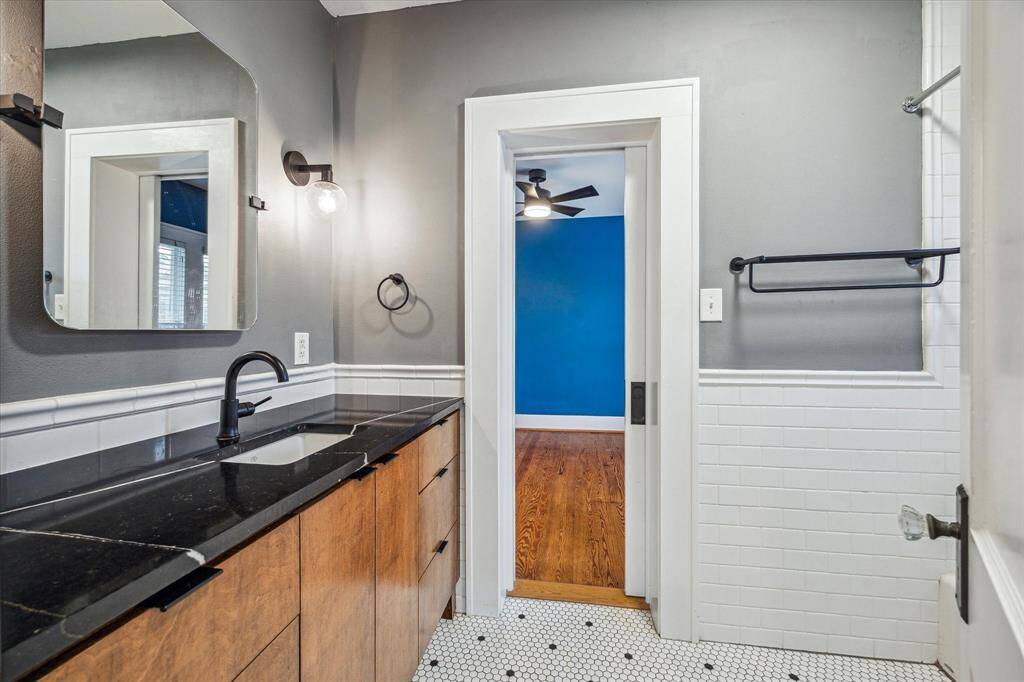 An additional view of the Bath reveals its jack and jill style, providing convenient access from both bedrooms. It features a practical shower/tub combo, perfect for versatile use.