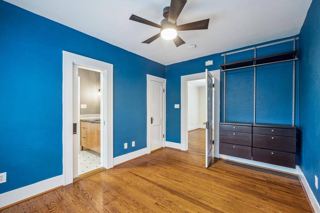 This Bedroom offers a closet and built-in Elfa shelving, providing ample storage solutions that effectively enhance the classic 1926 home's original closet space.