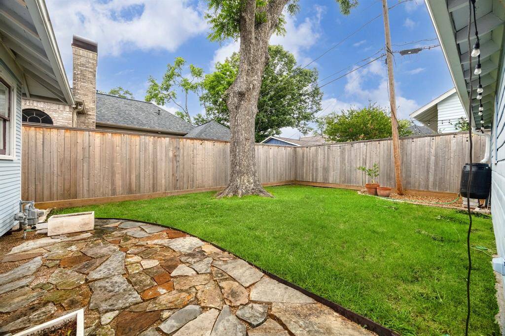 Fabulous, fully fenced backyard offers a perfect blend of nature and comfort. Enjoy the lush grass that invites outdoor play and relaxation, shaded by an impressive pecan tree that adds both beauty and character. The addition of pavers creates a stylish space ideal for your patio furniture, making it perfect for entertaining or simply unwinding in a serene setting.