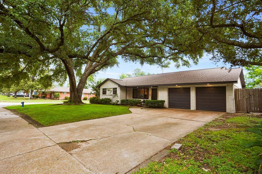 Charming single-story home, on a corner lot, with a welcoming front yard and a 100± year old oak tree. Features a double driveway leading to a two-car garage.