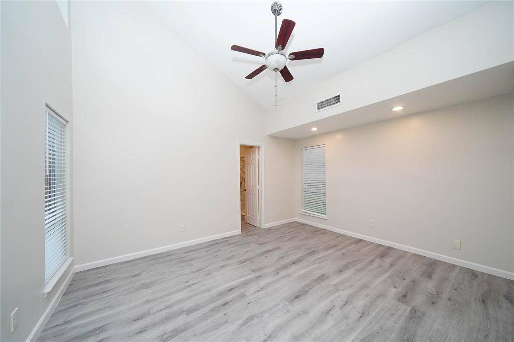 Primary bedroom (15'x12') has high ceilings and new fan