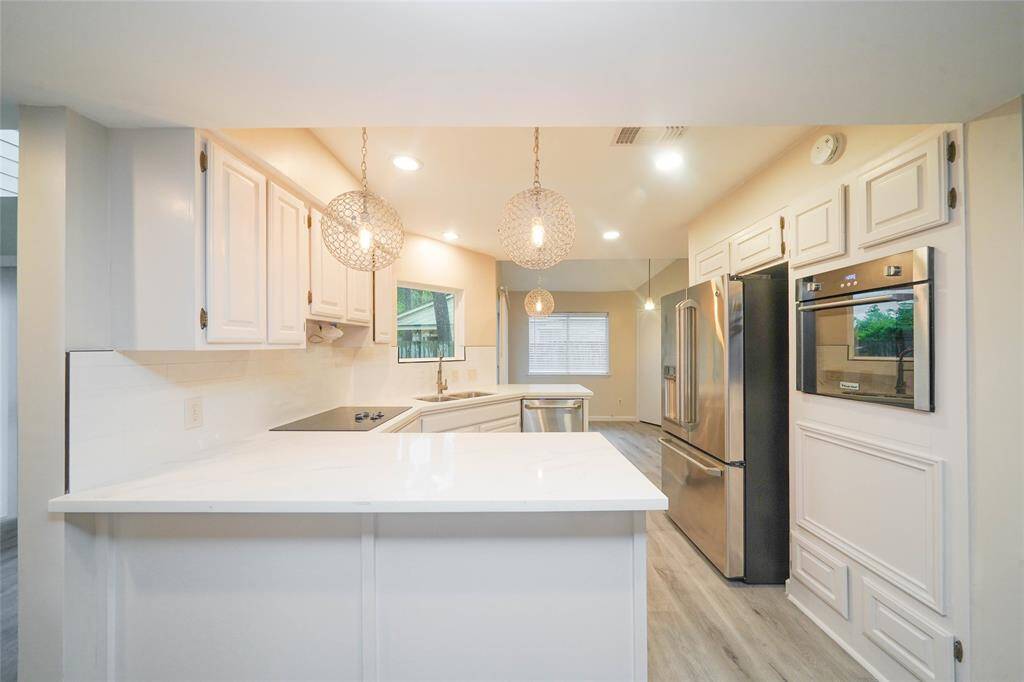New counters, fixtures and appliances in kitchen. Refrigerator included