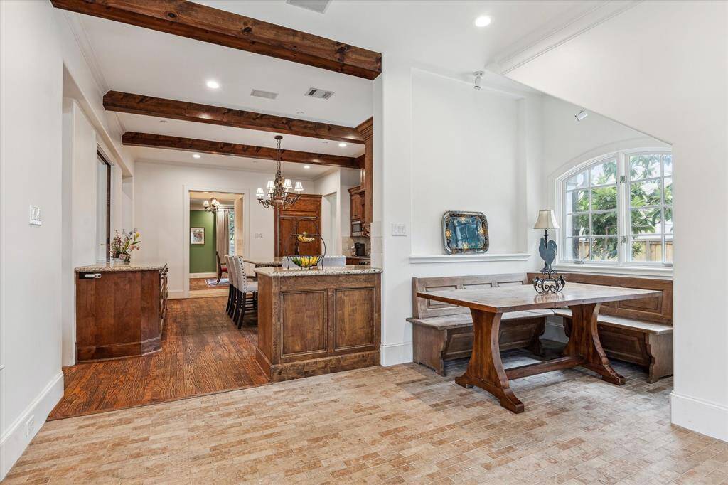 This breakfast room offers a spacious layout with an open connection to the kitchen, allowing for easy flow and interaction between spaces. Its generous size accommodates casual dining comfortably, while large windows provide ample natural light.