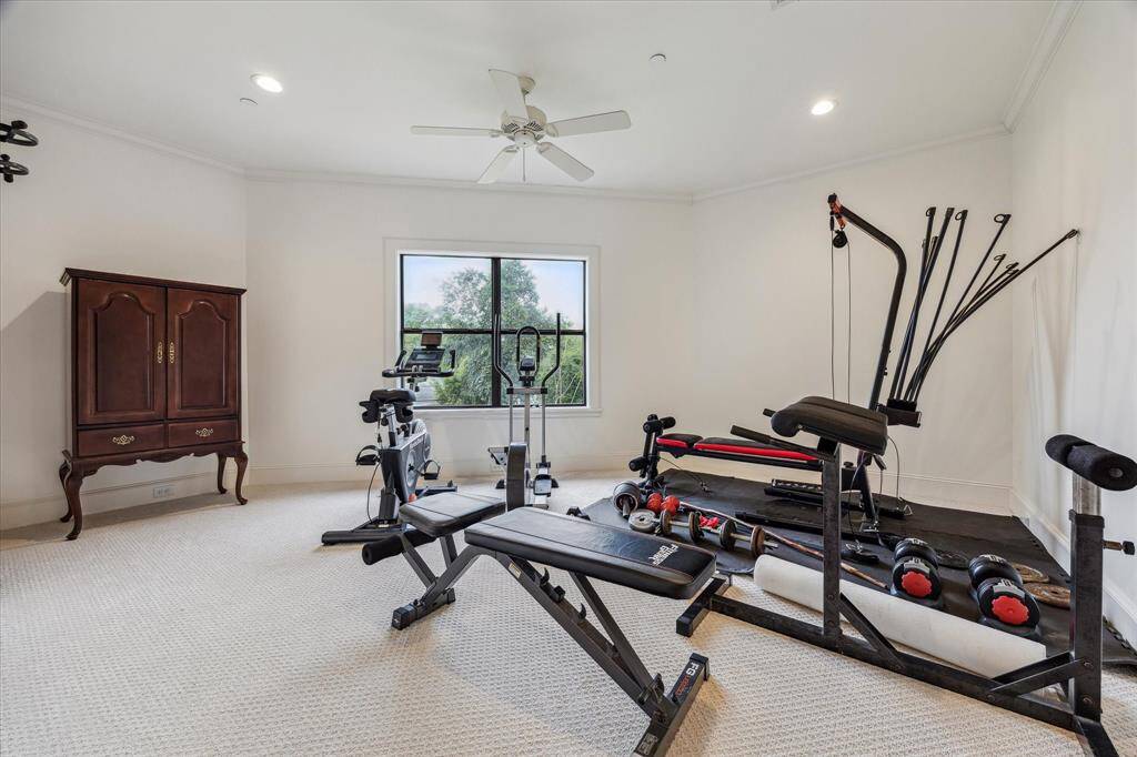 This flex room features a spacious layout with neutral carpeting, recessed lighting, and a ceiling fan. A large window allows for natural light and provides outdoor views, creating a bright and versatile space suitable for multiple uses.