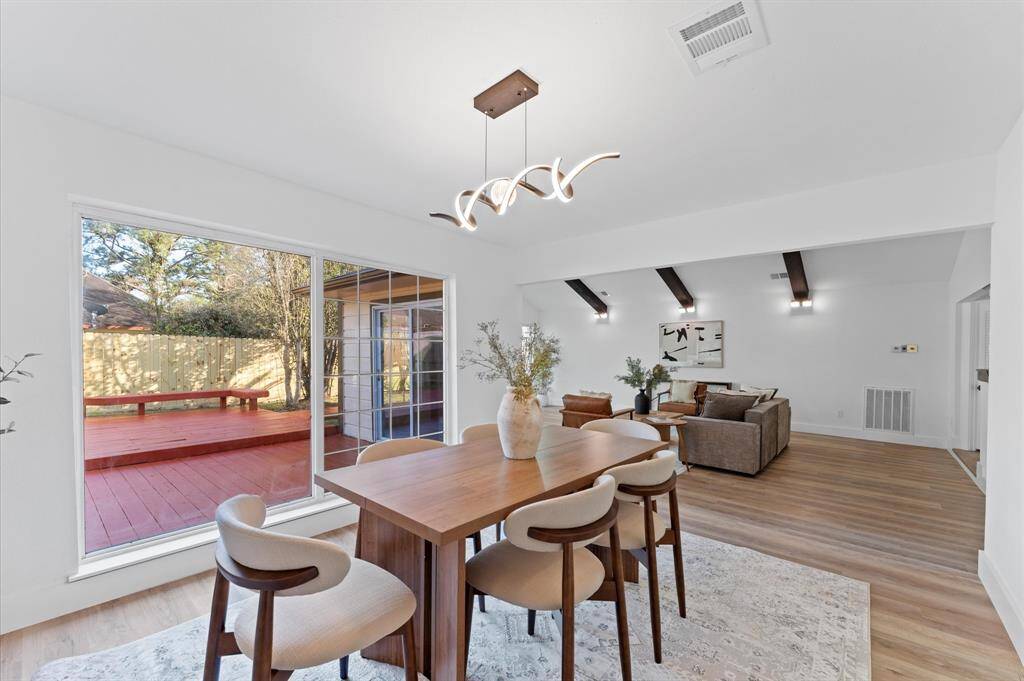 Expansive dining area with plenty of natural light and beautiful views of the patio, creating the perfect space for family meals and gatherings.