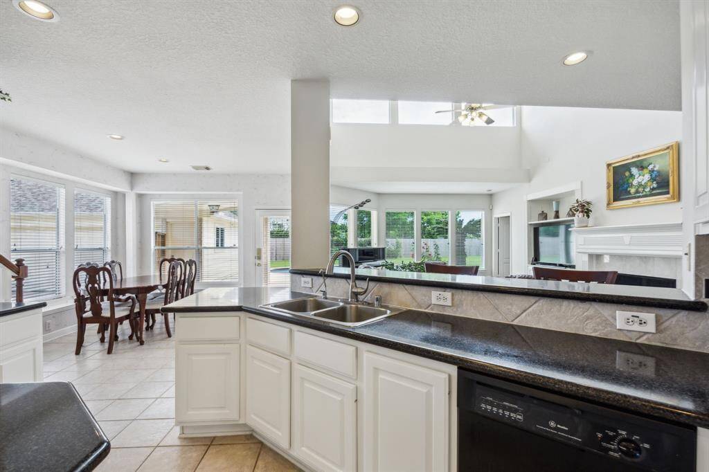 The kitchen’s generous counter space and sightlines to the living room make it easy to serve, socialize, and supervise; all at once. Natural light flows freely between both spaces, while the warm finishes and cohesive design provide a welcoming atmosphere that ties the heart of the home together with comfort and style.