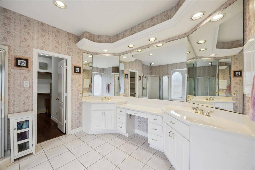 Step into the spa-inspired primary bathroom, where comfort meets elegance. Featuring dual vanities with sleek countertops and ample storage, the space is designed for both convenience and style. A dedicated vanity area offers the perfect spot for getting ready in the morning or winding down in the evening.