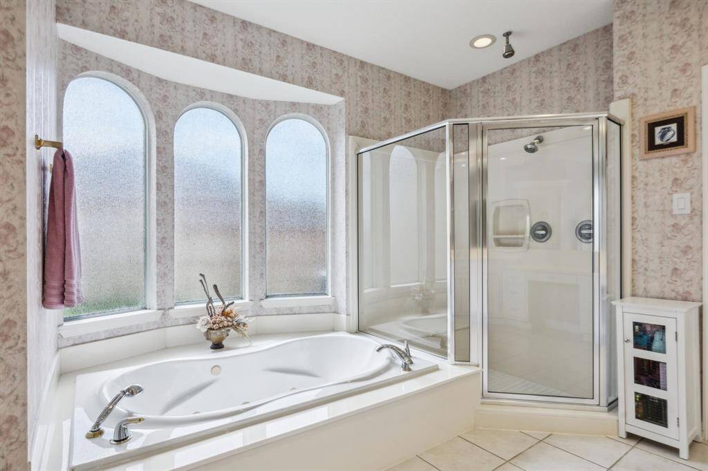 The luxurious soaking tub invites you to unwind in a tranquil setting, creating the ultimate retreat after a long day. With a soothing color palette and thoughtfully designed layout, this bathroom blends functionality with a spa-like atmosphere, making everyday living feel like a getaway.