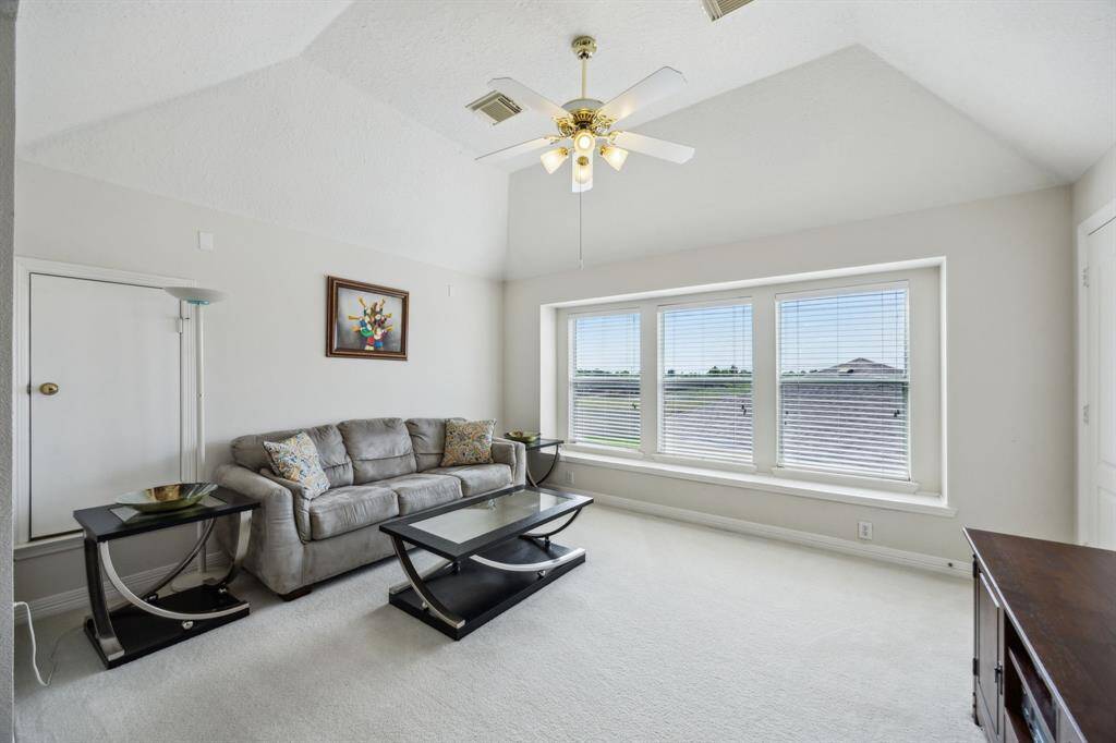 The spacious upstairs gameroom features plush carpeting for comfort and warmth, creating an inviting space for relaxation and entertainment. Large windows flood the room with abundant natural light, enhancing the open and airy atmosphere. Whether used as a family hangout, play area, or media room, this versatile space offers endless possibilities for fun and leisure.