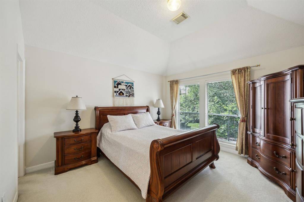The spacious secondary bedroom upstairs offers comfort and versatility, perfect for family members or guests. Featuring plush carpeting and ample natural light streaming through generous windows, this room creates a warm and inviting atmosphere. Its generous proportions easily accommodate a variety of furniture arrangements, making it ideal as a restful retreat, playroom, or home office. Thoughtfully positioned near the game room and other bedrooms, it provides both privacy and convenience.