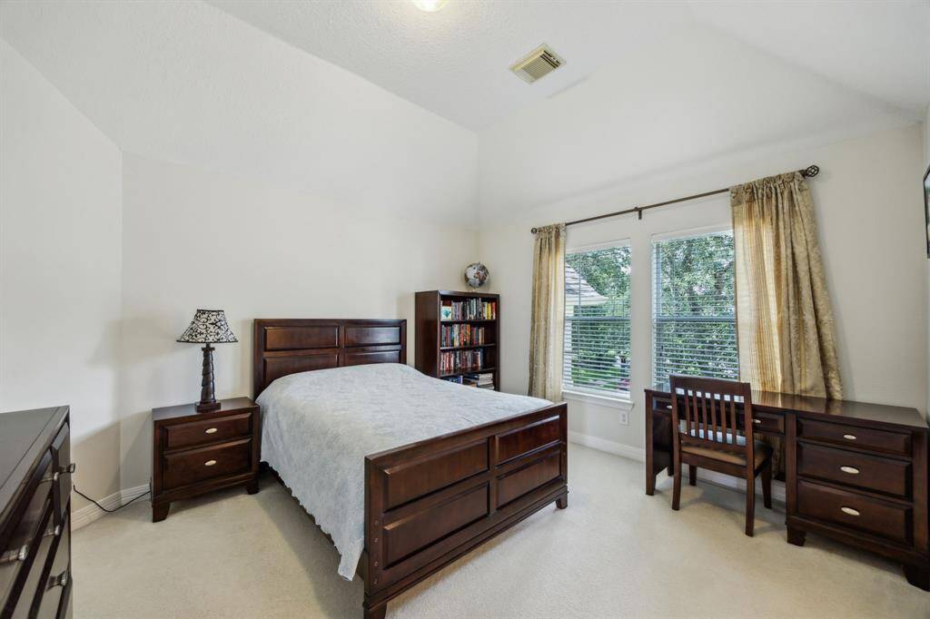 The third upstairs bedroom mirrors the comfort and charm found throughout the home, featuring soft carpeting and abundant natural light that fills the space with a warm, airy feel. Its generous size allows for flexible use, whether as a cozy bedroom, study, or creative space.