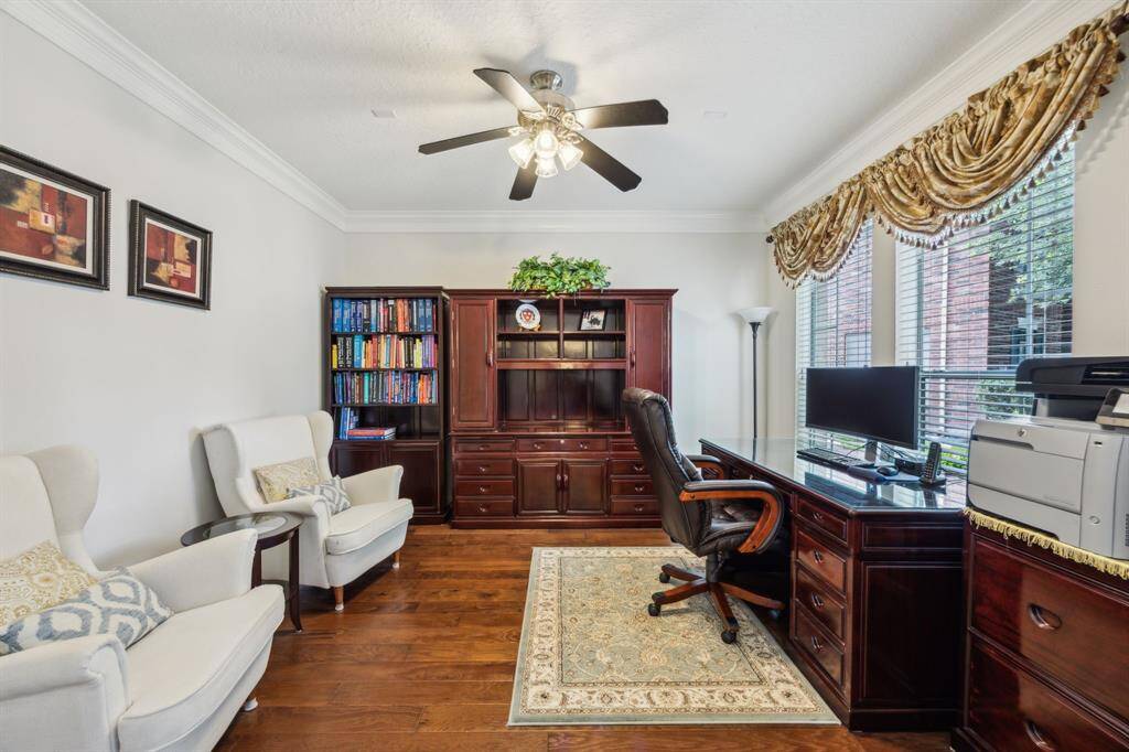 From this vantage point, the study reveals its true potential as a serene and functional workspace. Bathed in natural light from the front-facing windows, the room offers a calming view of the quiet cul-de-sac, adding both inspiration and tranquility to your day.