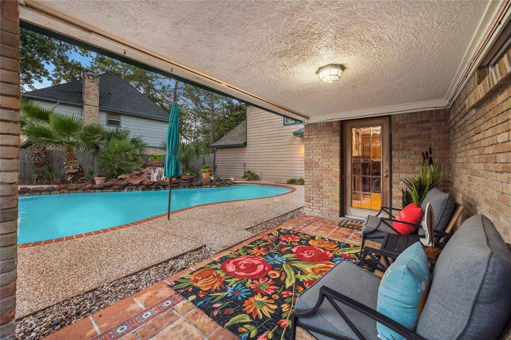 This cozy covered outdoor patio is a perfect spot for relaxation and enjoying the fresh air.