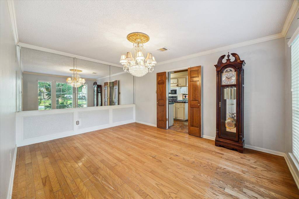 This dining room connects to the kitchen through double wooden doors.