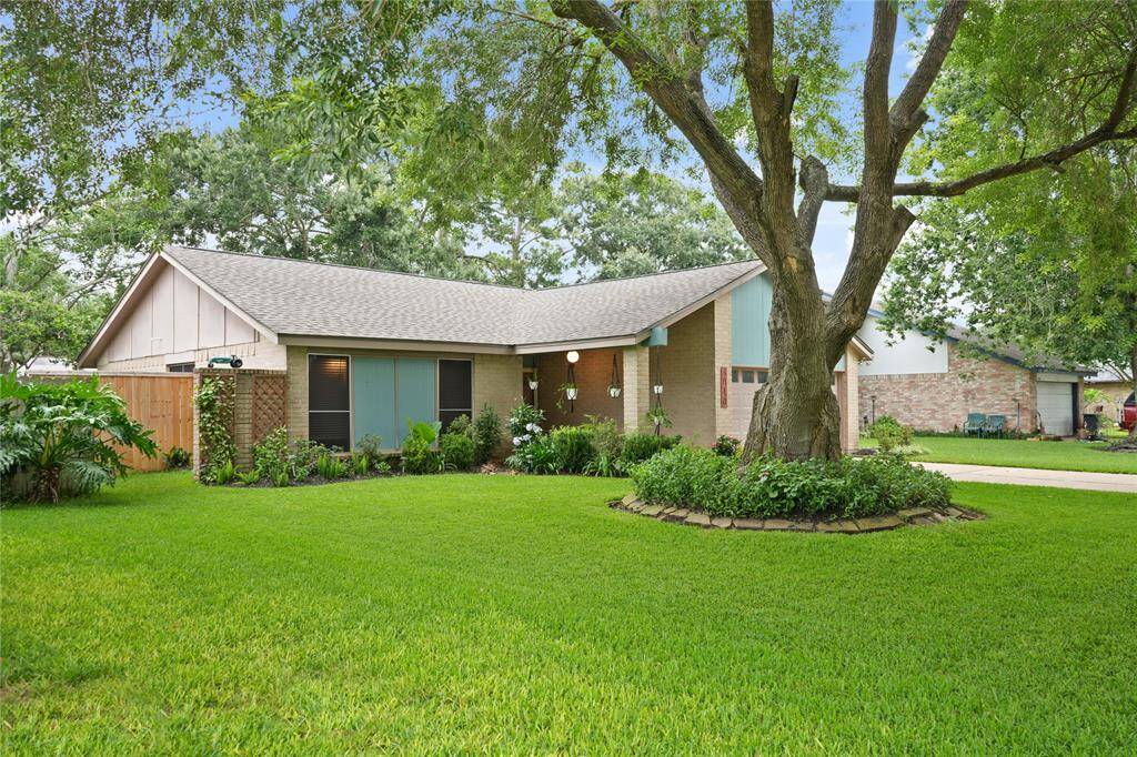 Charming single-story home with a well-maintained lawn, mature trees, and a two-car garage. Features a welcoming front porch and clean, simple landscaping for great curb appeal.