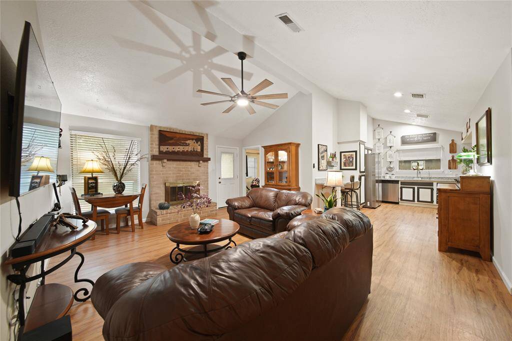 The open layout creates a harmonious flow between the cozy seating zone and the spacious kitchen. Perfect for entertaining guests or enjoying family gatherings, this space is designed to offer both comfort and connectivity.