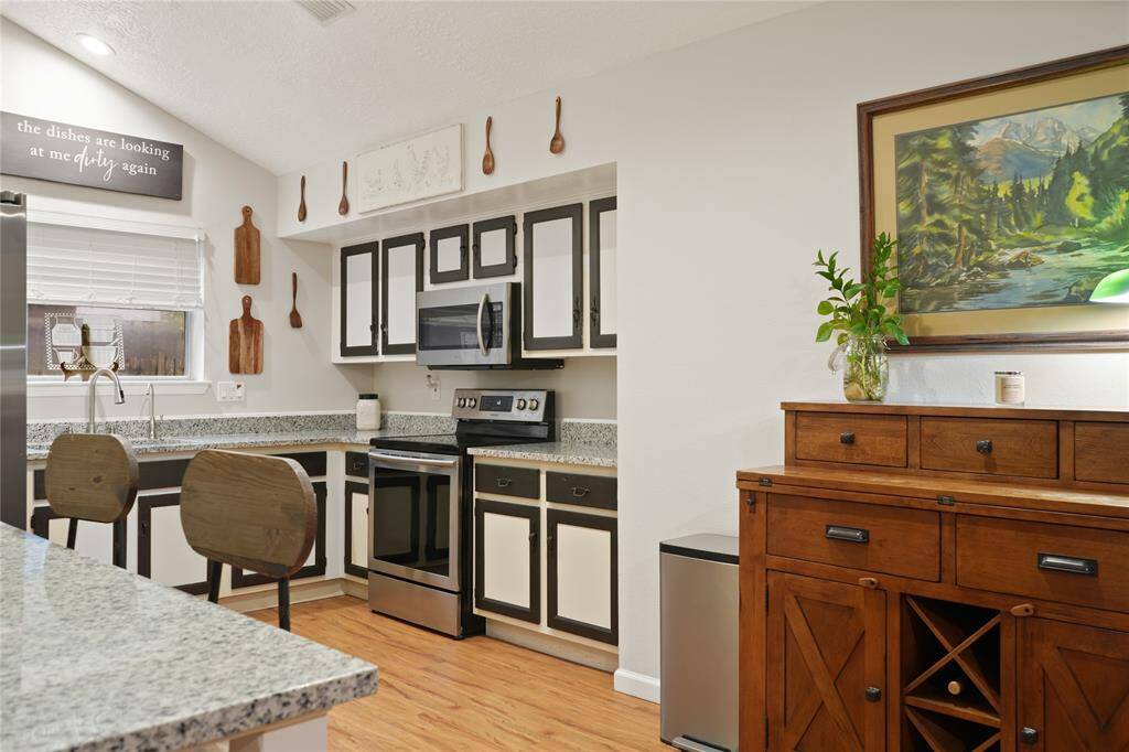 The open living floor plan effortlessly connects each space, allowing the host to remain engaged with guests while entertaining. The luxurious vinyl plank flooring extends throughout the home, providing a harmonious flow that enhances both style and function.