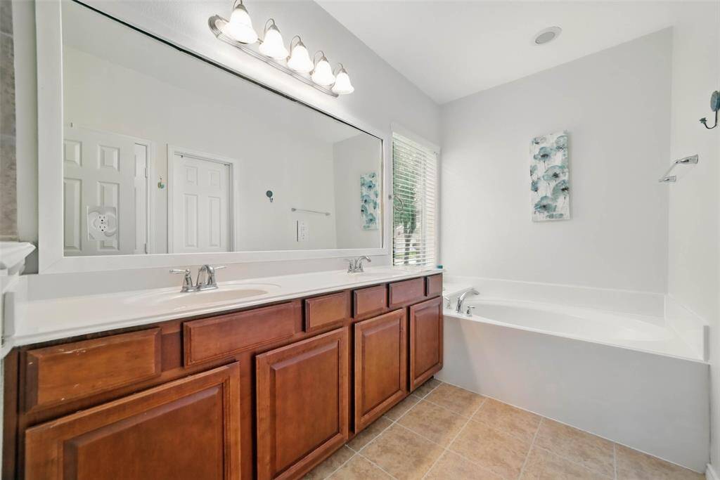 Primary bath also features double sinks and a garden tub.