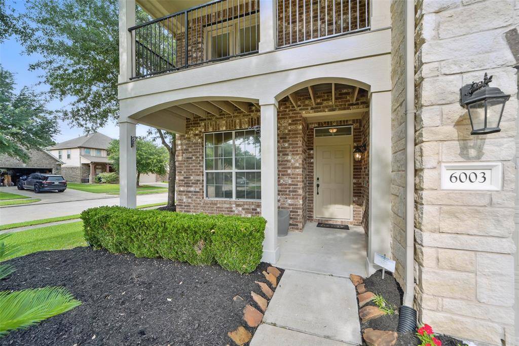 Covered front porch and an upstairs balcony.